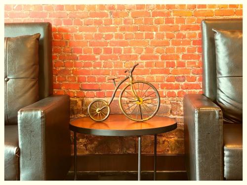 a bike sitting on a table in front of a brick wall at Hotel Pearl Royal # Crown Puri Near Jagannath Temple & Puri Beach # Fully Air Conditioning #Restaurant -Free Wi-Fi # Parking -Top Rated Hotel In Puri in Puri