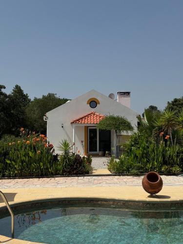 a house with a swimming pool in front of it at Casa dos Sobreiros in Palmela