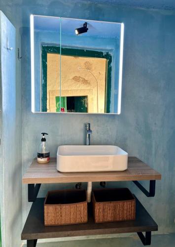 a bathroom with a sink and a mirror at Moundros 1620 Venetian Residence in Moúndros