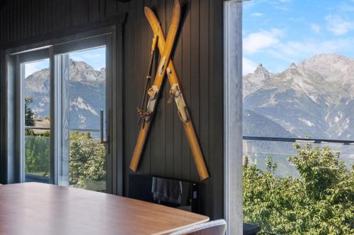 a pair of axes hanging on a wall next to a window at Kool Kabin - 8 pers - vue, charme et confort in Plan Fey