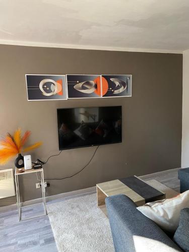a living room with a tv on a wall at Petit nid doué in Frameries