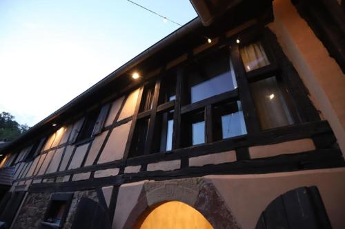 a building with windows on the side of it at The Farm 1807 authenticity & modernity in Hangenbieten