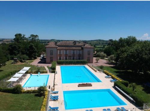 an aerial view of a house with two swimming pools at Le refuge barbezien in Lombez