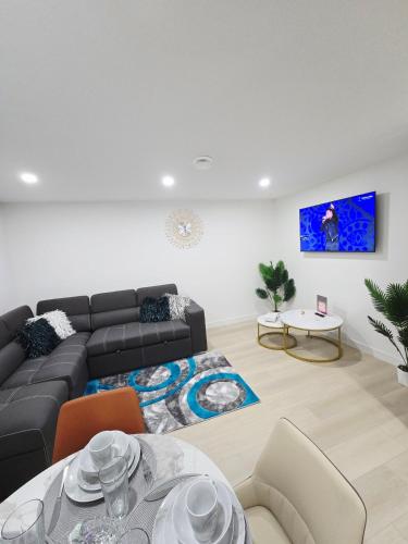 a living room with a couch and a table at Cozy Modern Spacious 2 Bedroom and full kitchen in Southwest Calgary in Calgary