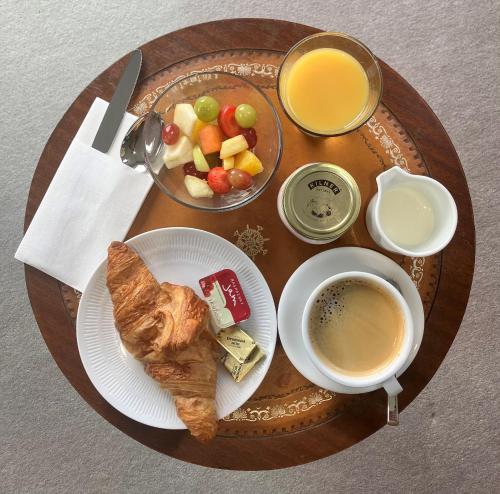 a table with a plate of food and a cup of coffee at Maine House Galgorm in Ballymena