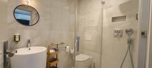 a bathroom with a shower and a toilet and a sink at Les 4 Saisons in Kruth