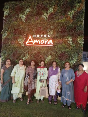 a group of women standing in front of a sign at HOTEL AMORA - Rajnandgaon in Rāj Nāndgaon