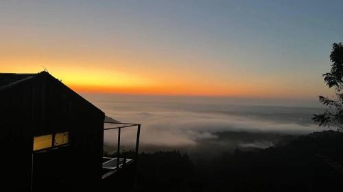 a view of the sunset from a house in the clouds at 4000Dao- A Hilltop Hideaway & Experience in Doi Tung 
