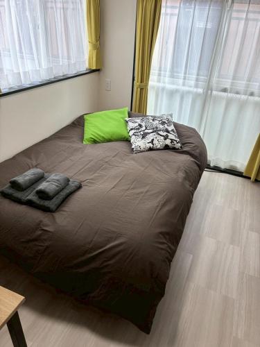 a large bed in a room with a window at Corpo SKR by Tranova in Musashino