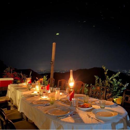 a long table with plates of food and lights at 4000Dao- A Hilltop Hideaway & Experience in Doi Tung 