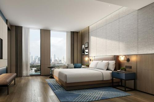 a bedroom with a large bed and a large window at Four Points by Sheraton Kunshan in Kunshan