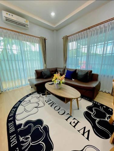 a living room with a couch and a table at Fiw And Fair Pool Villa Hatyai in Hat Yai Intl
