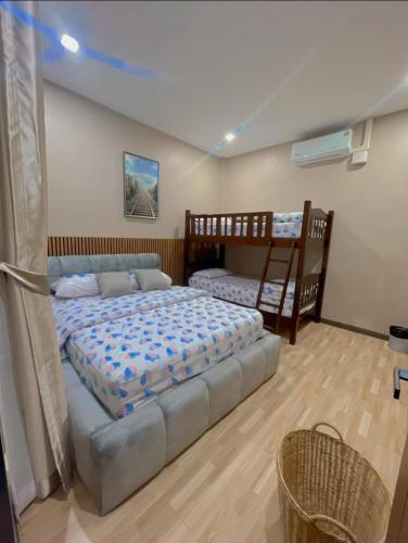 a bedroom with two beds and a bunk bed at Fiw And Fair Pool Villa Hatyai in Hat Yai Intl