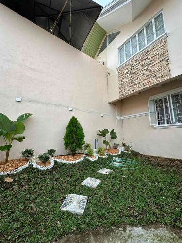 a house with a garden in front of it at DY Casa in Puting Kahoy