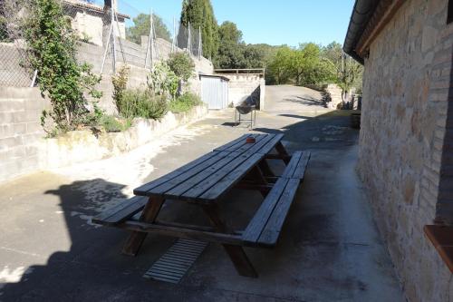 a picnic table sitting on the side of a building at Cal Fuse in Fonollosa