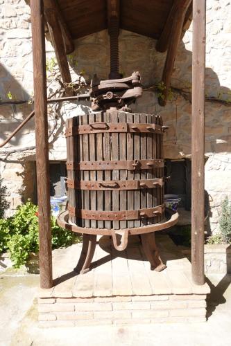 a large wooden chair sitting under a building at Cal Fuse in Fonollosa