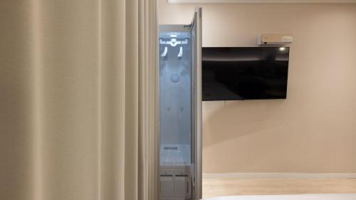 a video game console in a room with a curtain at Browndot Hotel Jeonju Junghwasan in Jeonju