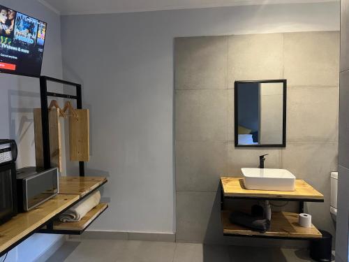 a bathroom with a sink and a mirror at Casa Bravo - Cozy Traveller in Pretoria