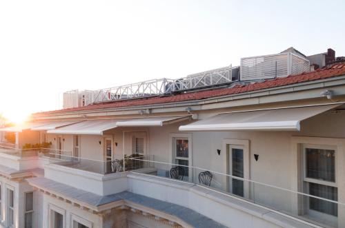 a building with a balcony with a train on top of it at Casa Foscolo Hotel, Istanbul, a Member of Design Hotels in Istanbul
