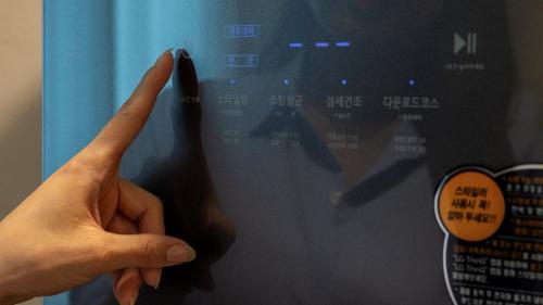 a person holding their index finger up to a wall at Browndot Hotel Jeonju Junghwasan in Jeonju