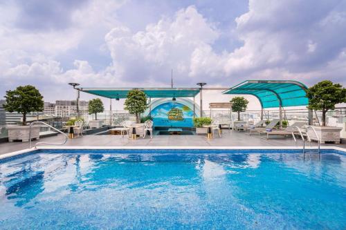 a swimming pool on the roof of a building at Le Saigon Grand Hotel in Ho Chi Minh City