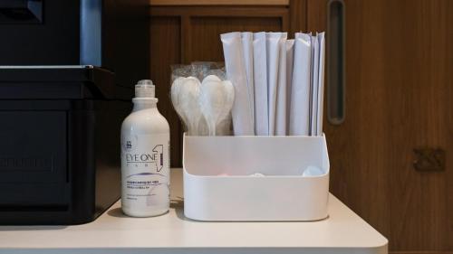 a bottle of bleach and a box of tooth brushes at Browndot Hotel Jeonju Junghwasan in Jeonju