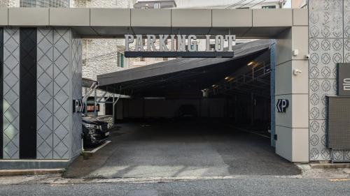 a parking lot entrance to a building with a parking lot sign at Browndot Hotel Jeonju Junghwasan in Jeonju