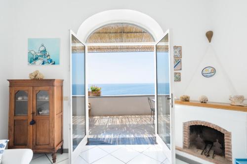 a glass shower in a living room with a fireplace at Casa William in Positano