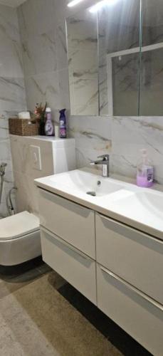 a white bathroom with a sink and a toilet at Villa Nanou Riviera in Nice