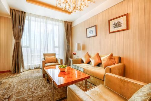 a living room with a couch and a table at Best Western Premier Tuushin Hotel in Ulaanbaatar