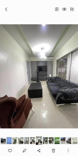 Una gran sala de estar con sofás y un televisor. en Sweet home, en Lagos