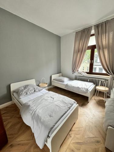 a bedroom with two beds and a window at Duisburg Flats 24 in Duisburg