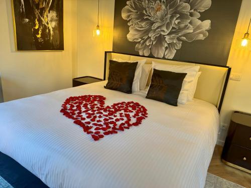 a couple of red hearts laying on a bed at Brouwerij De Sleutels in Bruges