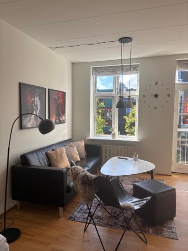 a living room with a couch and a table at Lejlighed Østergade Herning in Herning