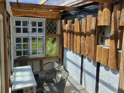 a patio with chairs and a table and a window at Holiday Home Redlef by Interhome in Søllested
