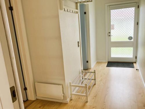 a hallway with a door and a stair case at Apartment Gudke - 50m from the sea by Interhome in Bogense