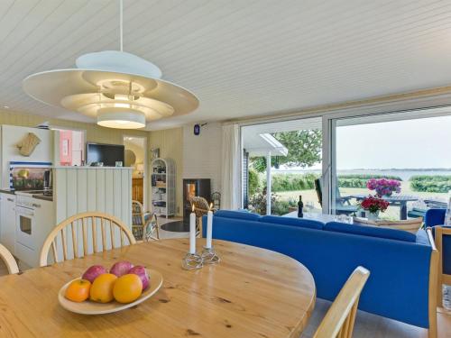 a dining room table with a plate of fruit on it at Holiday Home Eddy - 50m from the sea by Interhome in Kragenæs