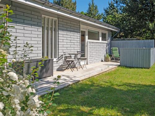 a house with a wooden deck in the yard at Holiday Home Torhild - 150m from the sea by Interhome in Martofte
