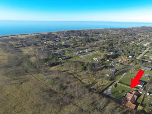 an aerial view of a village with a red arrow at Holiday Home Gretta - 400m from the sea by Interhome in Dannemare