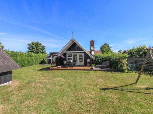 a house with a large yard in front of it at Holiday Home Elbert - 100m from the sea by Interhome in Otterup
