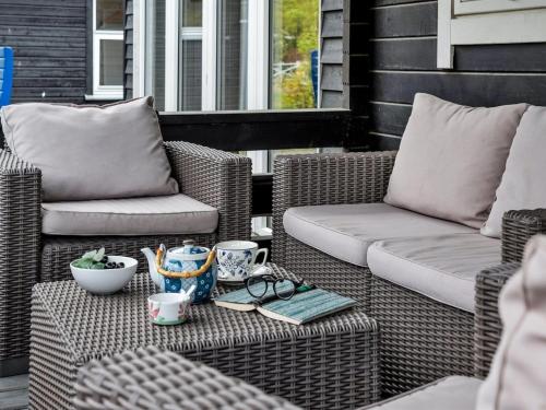 two wicker chairs and a couch on a patio at Holiday Home Hardina - 300m from the sea by Interhome in Martofte