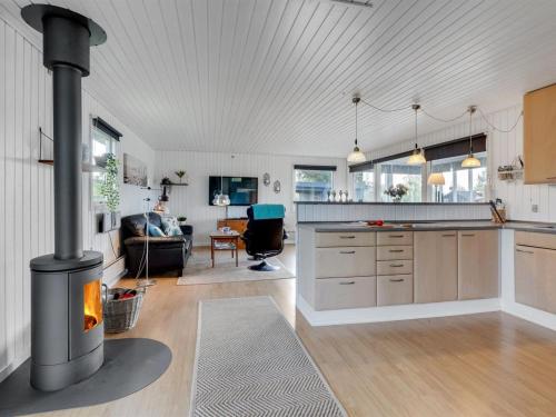 a kitchen with a stove in the middle of a room at Holiday Home Ilene - 1km from the sea by Interhome in Bogø By