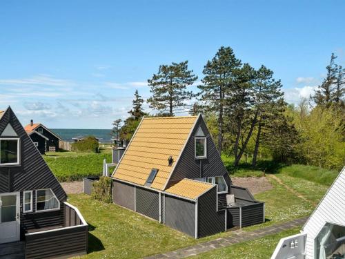 a home with a yellow roof on the grass at Holiday Home Pihla - 50m from the sea by Interhome in Gedser