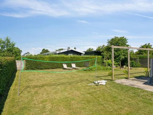 a net on the grass in a yard at Holiday Home Thomas - 120m from the sea by Interhome in Otterup