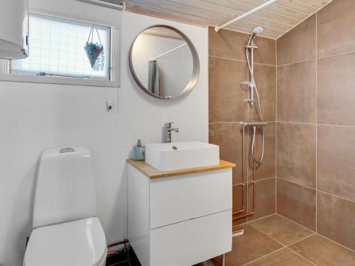 a bathroom with a sink and a mirror at Holiday Home Sazur - 75m from the sea by Interhome in Mesinge