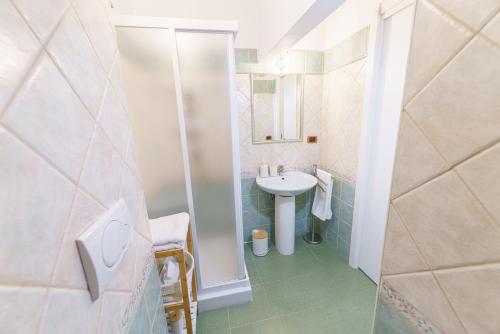 a bathroom with a sink and a shower at Dimora Matine Pisticci in Pisticci