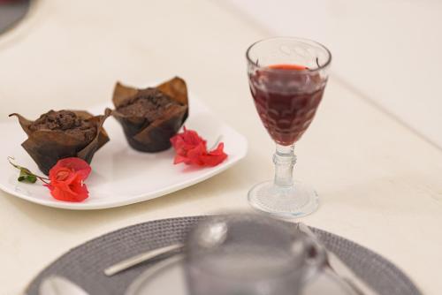 a table with a plate of chocolate chips and a wine glass at Dimora Matine Pisticci in Pisticci