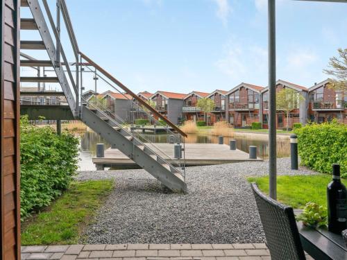 a metal stairway in a park with buildings at Apartment Allyson - 450m from the sea by Interhome in Bogense