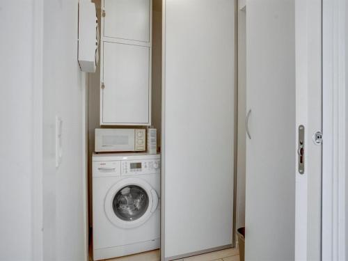 a kitchen with a washing machine and a microwave at Apartment Allyson - 450m from the sea by Interhome in Bogense