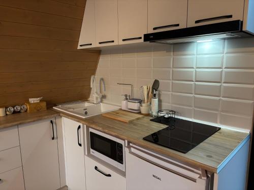 a kitchen with a sink and a stove top oven at Space Trip Hotel in Artavaz